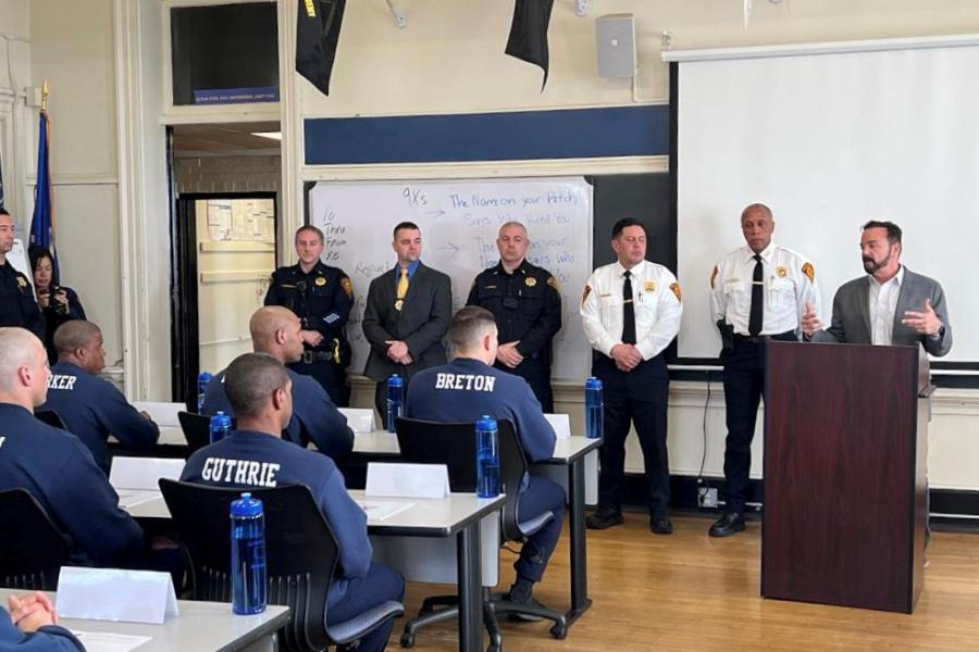 Photo of Mayor Ganim standing next to Chief Porter and other Bridgeport Police Officers as he speaks to class 45 at the Bridgeport Police Academy.