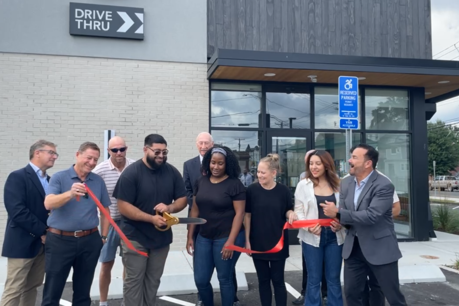 Photo of Mayor Ganim, Starbucks Staff, and Starbucks owner Richard Koris, cutting a red ribbon during the grand opening ceremony for the 1705 Fairfield Ave location of Starbucks