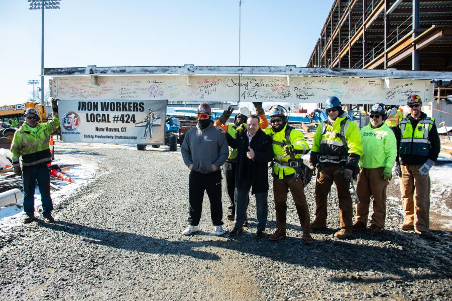 Photo of Mayor Ganim and construction workers, standing in front of steel beam to be placed during the topping-off ceremony at the new location for Bassick High School and Bridgeport Military Academy 