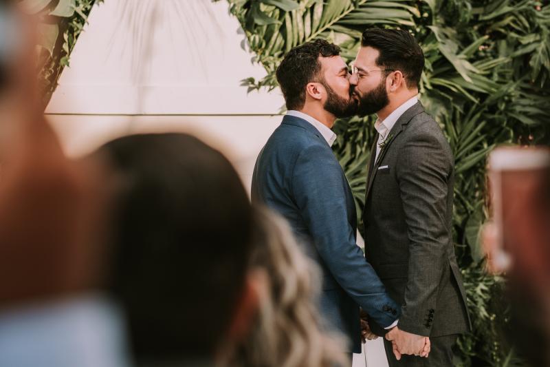 Married couple kissing at wedding