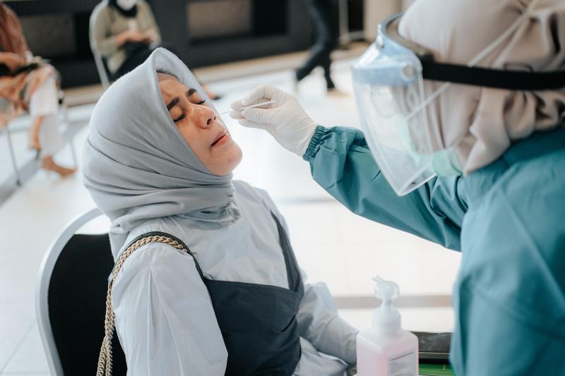 A woman getting tested for COVID-19 via nasal swab