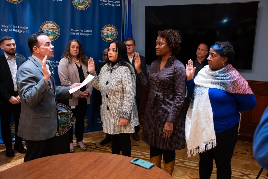 Photo of Mayor Ganim swearing in three of the Fair Rent Commissioners